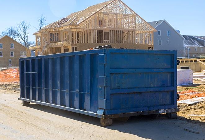 a group of residential dumpsters organized on a job site